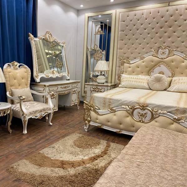 White and Gold Bedroom Set with Upholstered Headboard, Mirrored Accents, Lamps, and Chairs