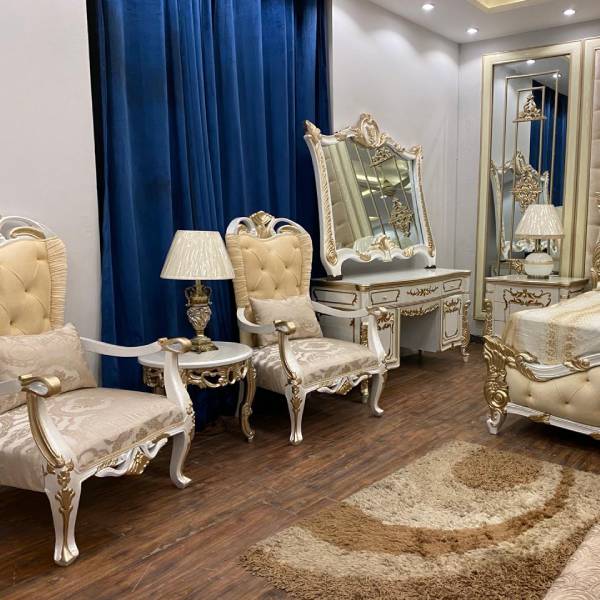 White and Gold Bedroom Set with Upholstered Headboard, Mirrored Accents, Lamps, and Chairs