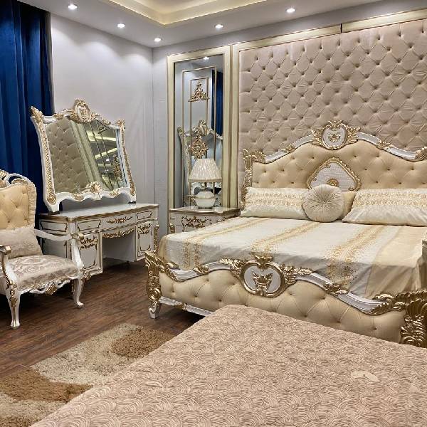 White and Gold Bedroom Set with Upholstered Headboard, Mirrored Accents, Lamps, and Chairs