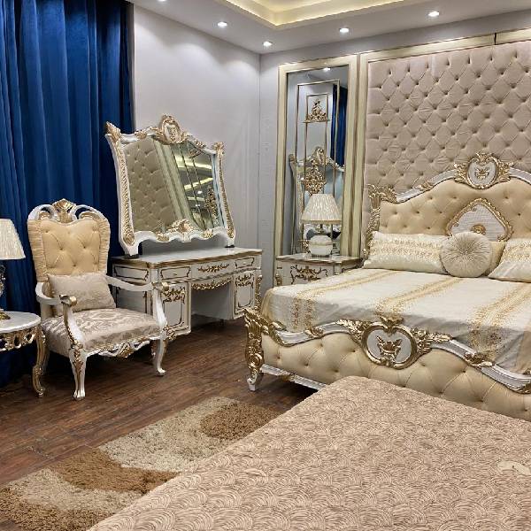 White and Gold Bedroom Set with Upholstered Headboard, Mirrored Accents, Lamps, and Chairs