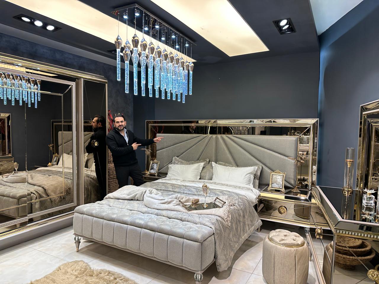 Luxury Silver Bedroom Suite with Mirrored Accents and Modern Chandelier